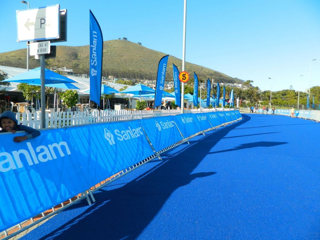 Sanlam event branding and blue carpet installation at an outdoor sports venue