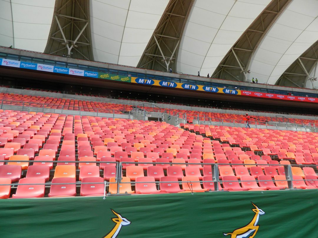 Empty stadium stands showing large-scale branded seating and signage
